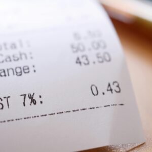 Detailed close-up image of a shopping receipt showing GST and total changes.